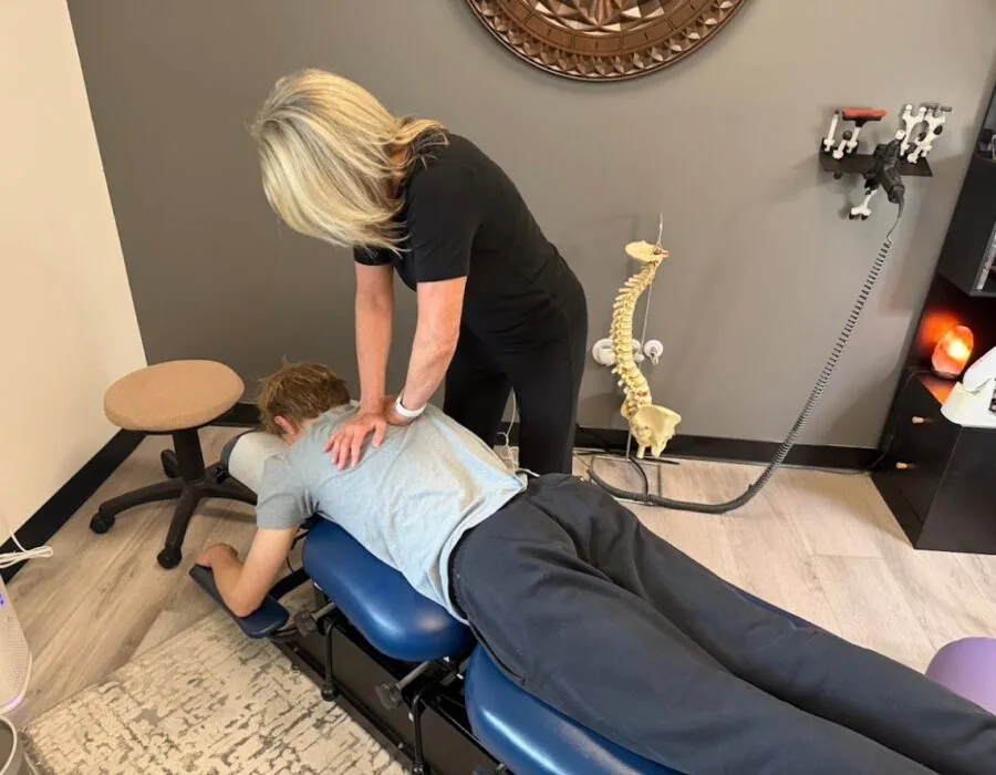 Dr. Shona giving a patient a thoracic adjustment